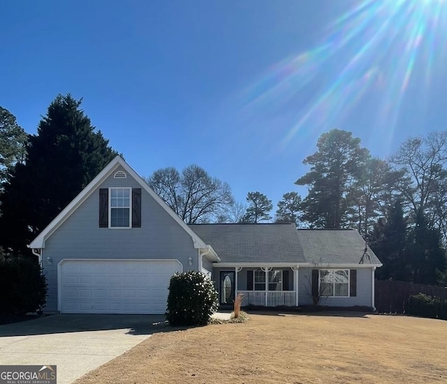 view of property featuring a garage and covered porch