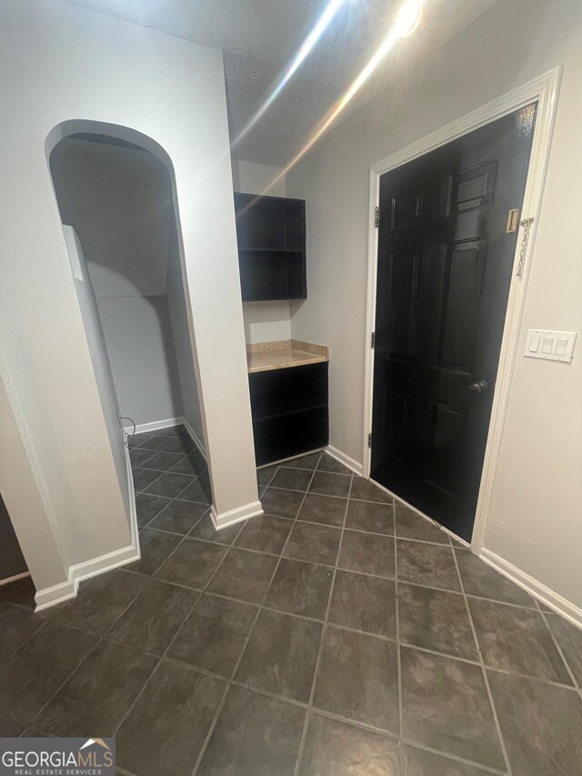 bathroom featuring tile patterned flooring and a textured ceiling