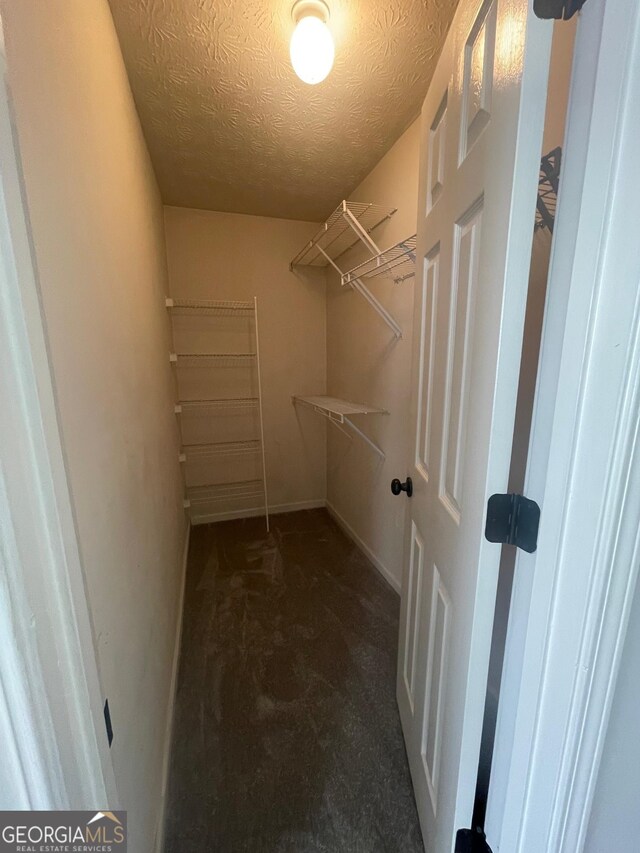 bathroom with vanity, toilet, and a textured ceiling