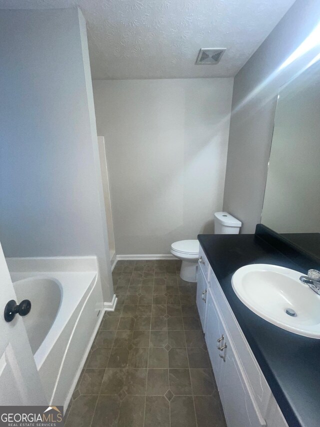 bathroom featuring tile patterned flooring, a textured ceiling, and separate shower and tub