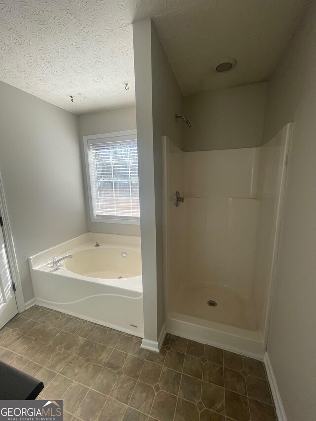 carpeted spare room with ceiling fan and a textured ceiling