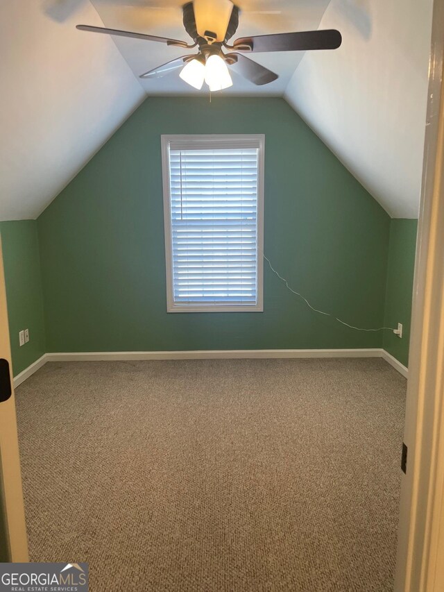 additional living space with carpet, lofted ceiling, and ceiling fan