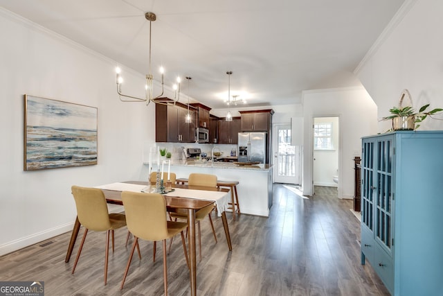 dining area featuring crown molding and dark hardwood / wood-style floors