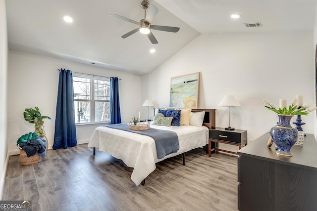 bedroom featuring light wood-style floors, recessed lighting, visible vents, and vaulted ceiling