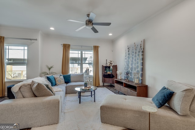 living room with crown molding and ceiling fan