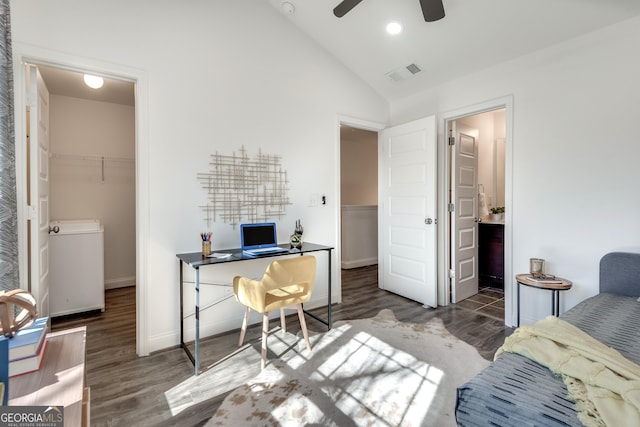 bedroom with visible vents, vaulted ceiling, a spacious closet, and wood finished floors