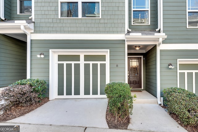 entrance to property featuring an attached garage