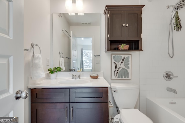 full bathroom featuring vanity, tiled shower / bath, and toilet