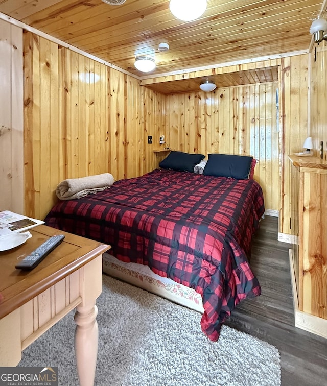 bedroom with wood ceiling, dark hardwood / wood-style floors, and wood walls