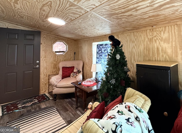 sitting room with hardwood / wood-style flooring, wooden walls, and wooden ceiling