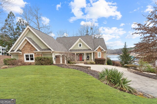 craftsman house featuring a water view and a front yard