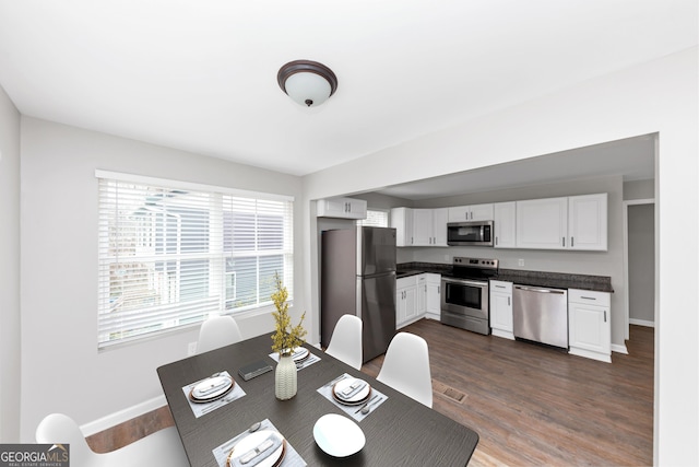 dining space featuring dark hardwood / wood-style flooring