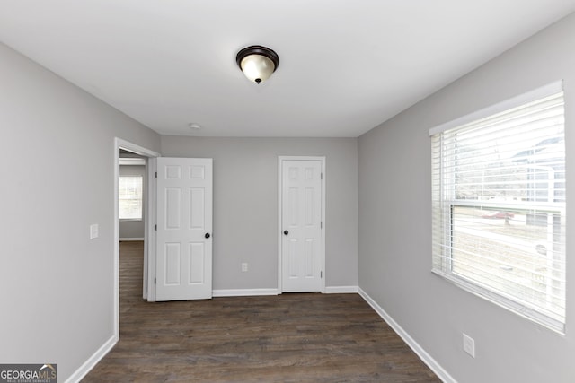 unfurnished bedroom with dark hardwood / wood-style floors