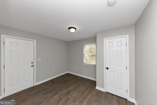 unfurnished room with dark hardwood / wood-style floors