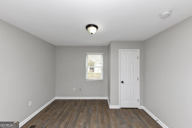 empty room featuring dark hardwood / wood-style floors