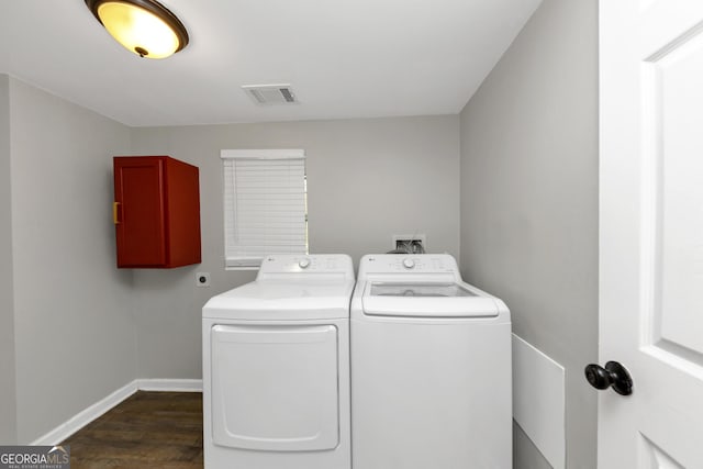 clothes washing area featuring independent washer and dryer and dark hardwood / wood-style flooring