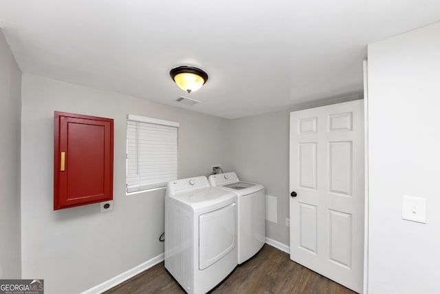 laundry area with dark hardwood / wood-style floors and washer and clothes dryer