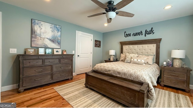 bedroom with ceiling fan and light hardwood / wood-style floors