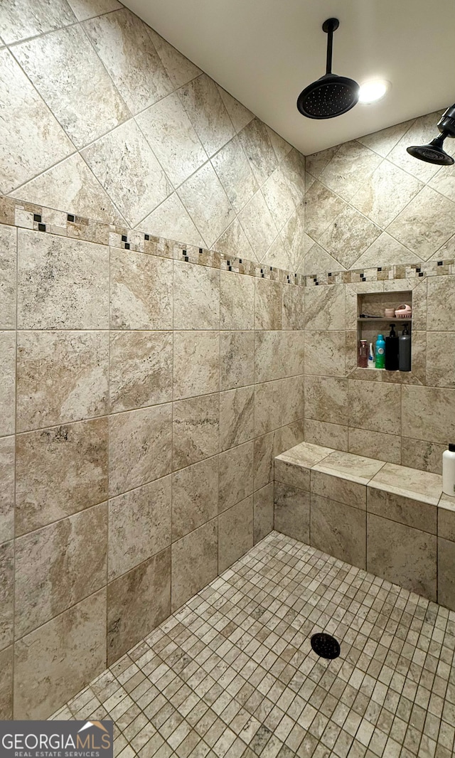 bathroom with a tile shower