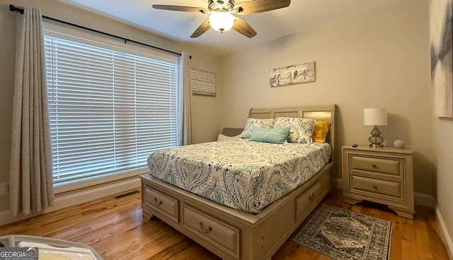 bedroom with ceiling fan and light wood-type flooring