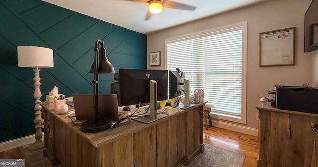 home office with hardwood / wood-style floors and ceiling fan