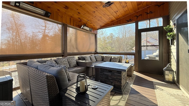 sunroom / solarium featuring lofted ceiling and wood ceiling