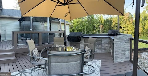 deck with a grill and an outdoor bar