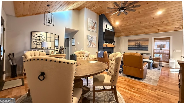 dining area featuring wood ceiling, ceiling fan, high vaulted ceiling, and light hardwood / wood-style flooring