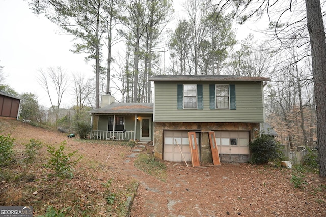 split level home with a garage and covered porch