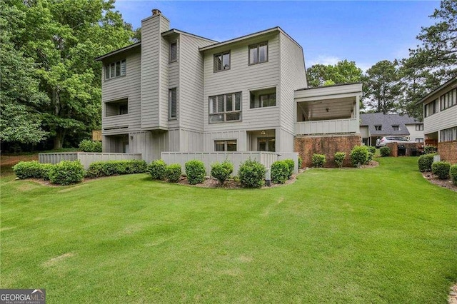 back of house featuring a lawn