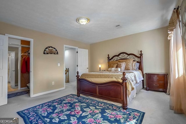 carpeted bedroom with a spacious closet