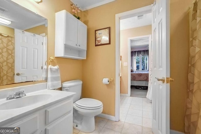 bathroom featuring tile patterned flooring, vanity, and toilet