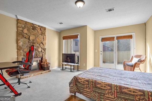 carpeted bedroom with crown molding, access to outside, and a textured ceiling