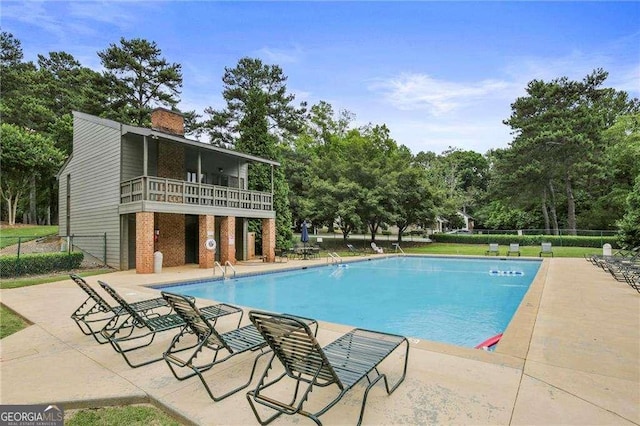 view of swimming pool with a patio