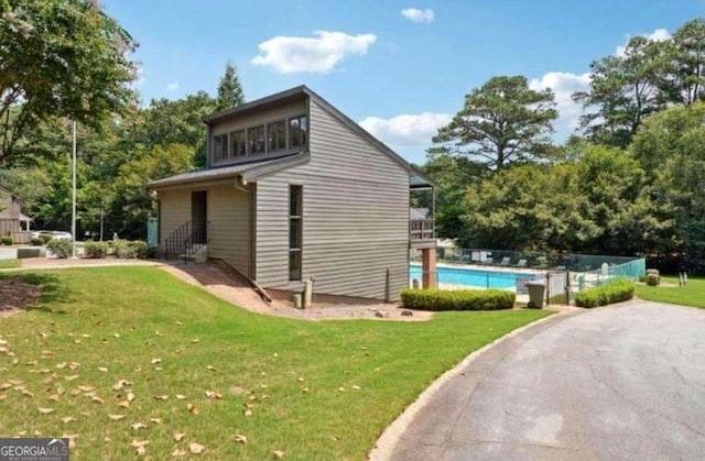 view of side of home featuring a yard