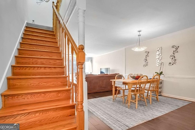 dining space featuring crown molding and wood-type flooring