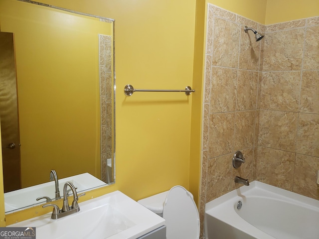 full bathroom with vanity, toilet, and tiled shower / bath combo