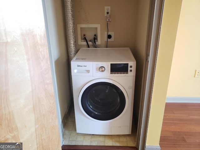 laundry area with washer / dryer and hardwood / wood-style floors