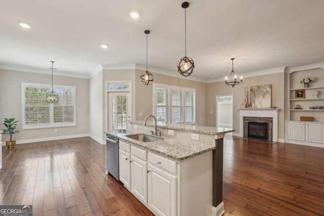 kitchen with pendant lighting, sink, an island with sink, white cabinets, and stainless steel dishwasher