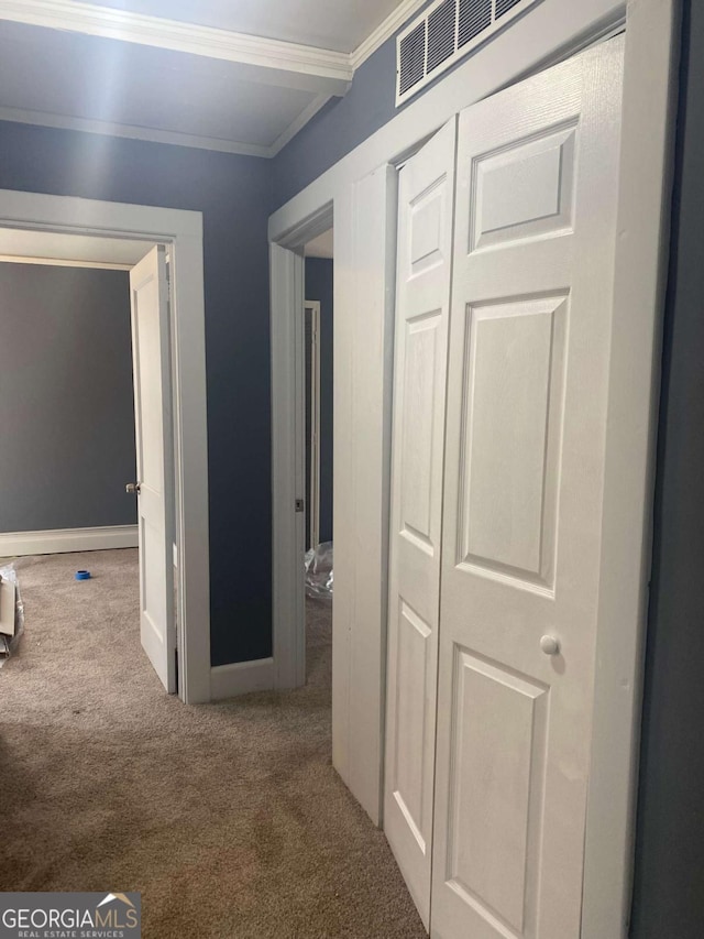 hall featuring crown molding and carpet flooring