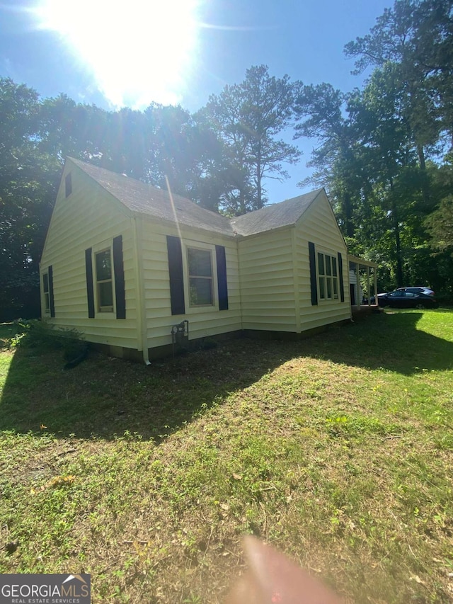 view of property exterior with a yard