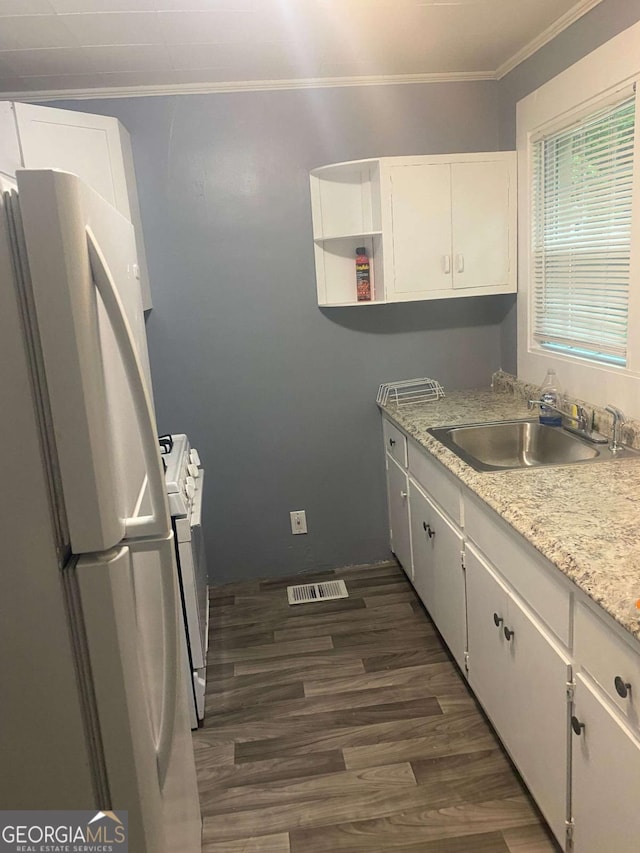 kitchen featuring sink, white appliances, dark hardwood / wood-style floors, light stone countertops, and white cabinets