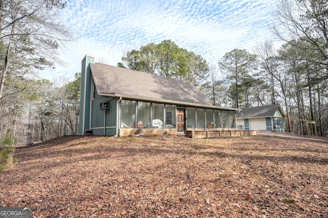 view of front of home with a sunroom