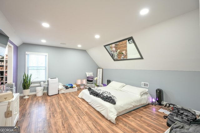 bedroom featuring hardwood / wood-style flooring and lofted ceiling