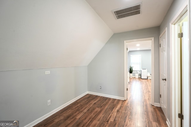 bonus room featuring lofted ceiling and dark wood-type flooring