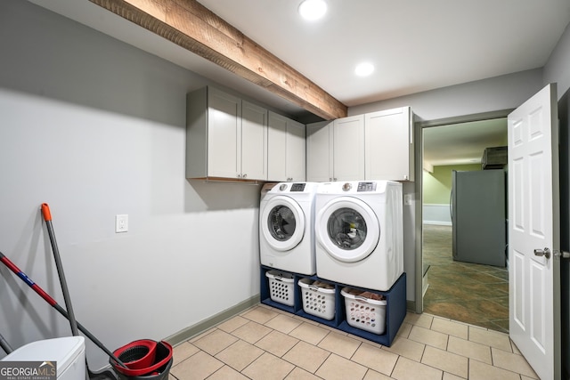 laundry room with washer and clothes dryer and cabinets