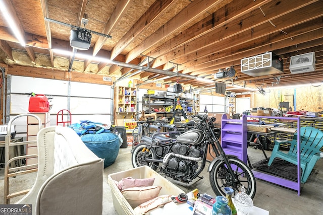 garage featuring a garage door opener and a workshop area