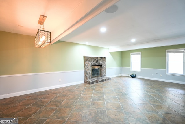 unfurnished living room with a stone fireplace