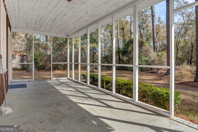 unfurnished sunroom with wooden ceiling