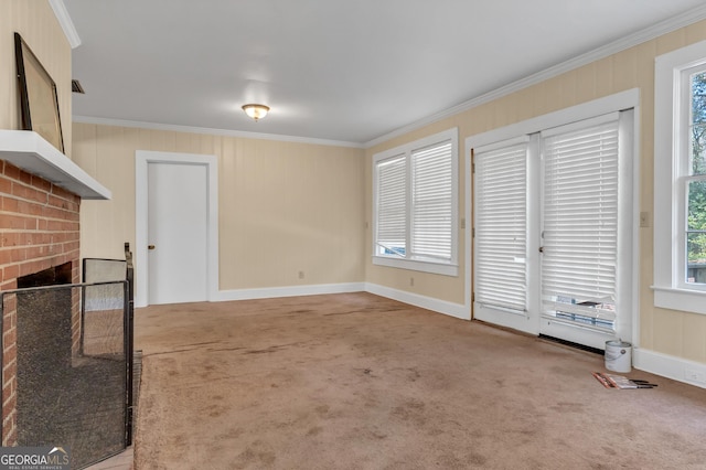 unfurnished living room featuring ornamental molding, carpet floors, and a fireplace